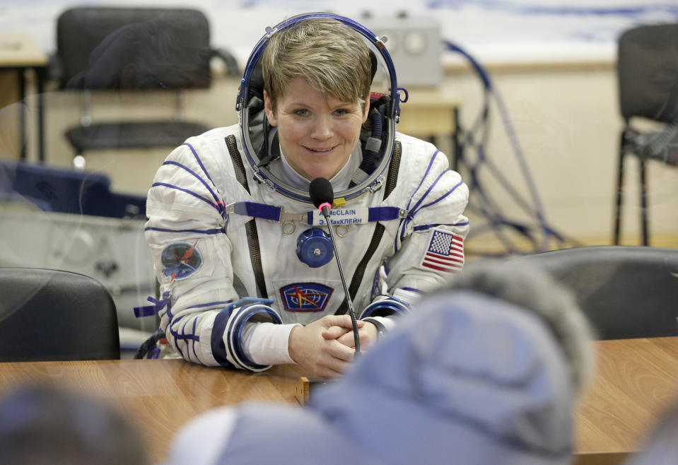 U.S. astronaut Anne McClain, member of the main crew of the expedition to the International Space Station (ISS), speaks with her relatives through a safety glass prior to the launch of Soyuz MS-11 space ship at the Russian leased Baikonur cosmodrome, Kazakhstan, Monday, Dec. 3, 2018. (AP Photo/Dmitri Lovetsky, Pool)