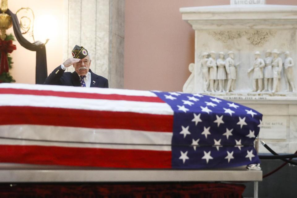 Warren Motts salutes the casket of the John Glenn as Glenn lies in repose, Friday, Dec. 16, 2016, in Columbus, Ohio. Glenn's home state and the nation began saying goodbye to the famed astronaut as he lies in state at Ohio's capitol building. Glenn, 95, the first American to orbit Earth, died last week. (AP Photo/John Minchillo)