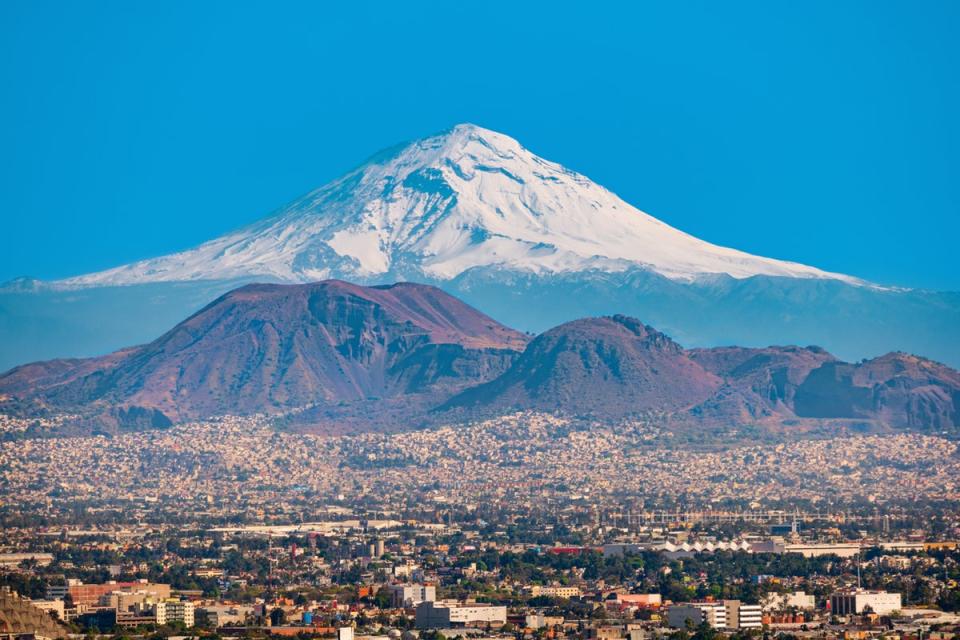 The Popocatepetl volcano provides a dramatic backdrop for the Mexican capital (Getty Images/iStockphoto)