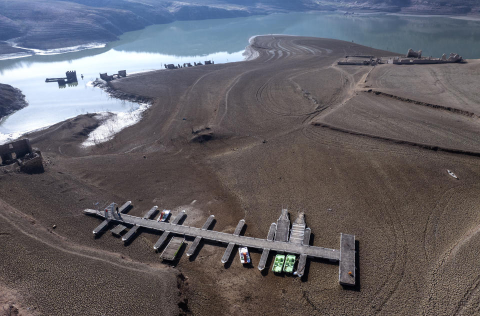 View of the Sau reservoir, which is only at 5 percent of its capacity, in Vilanova de Sau, about 100 km (62 miles) north of Barcelona, Spain, Friday, Jan. 26, 2024. Barcelona and the surrounding area of Spain's northeast Catalonia are preparing to face tighter water restrictions amid a historic drought that has shrunk reservoirs to record lows. Catalonia has recorded below-average rainfall for 40 consecutive months. Experts say that the drought is driven by climate change and that the entire Mediterranean region is forecast to heat up at a faster rate than many other regions in the coming years. (AP Photo/Emilio Morenatti)