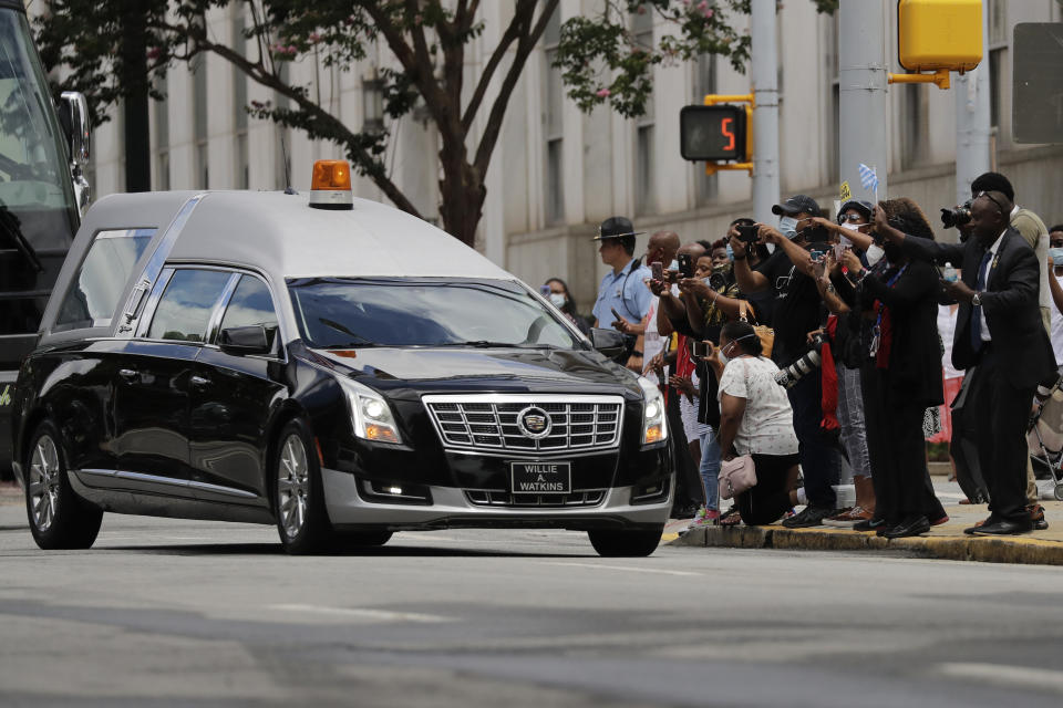 The hearse arrives at the state capital, where Rep. John Lewis will lie in repose, Wednesday, July 29, 2020, in Atlanta. Lewis, who carried the struggle against racial discrimination from Southern battlegrounds of the 1960s to the halls of Congress, died Friday, July 17, 2020. (AP Photo/Brynn Anderson)