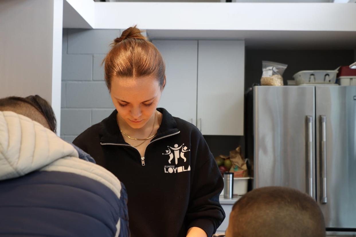 Emma Wilton has had to take a step back from administrative duties and help out in the kitchen ever since Jeunesse Loyola extended its after school programming to cover the entire day. (Matt D'Amours/CBC - image credit)