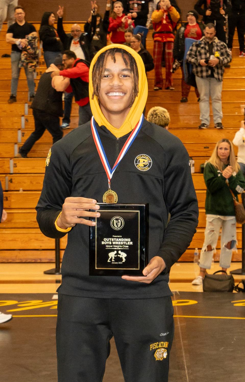 Piscataway's Sean Love holding the Upper Weights Outstanding Wrestler award at the 2014 GMC wrestling tournament.