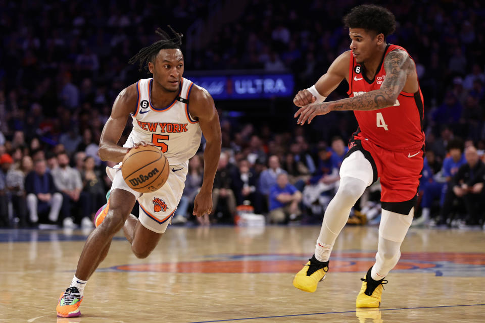 New York Knicks guard Immanuel Quickley (5) drives to the basket past Houston Rockets guard Jalen Green during the second half of an NBA basketball game Monday, March 27, 2023, in New York. (AP Photo/Adam Hunger)