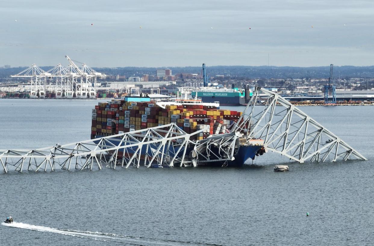 In this aerial image, the steel frame of the Francis Scott Key Bridge sits on top of a container ship after the bridge collapsed in Baltimore on March 26, 2024. <a href="https://www.gettyimages.com/detail/news-photo/in-this-aerial-image-the-steel-frame-of-the-francis-scott-news-photo/2107844094?adppopup=true" rel="nofollow noopener" target="_blank" data-ylk="slk:Jim Watson for Getty Images;elm:context_link;itc:0;sec:content-canvas" class="link ">Jim Watson for Getty Images</a>