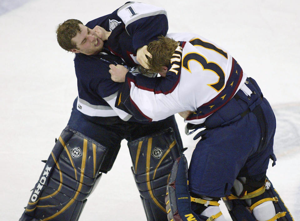 FILE - Atlanta Thrashers goalie Pasi Nurminen, right, fights with Edmonton Oilers' goalie Ty Conklin, left, during the third period of an NHL hockey game in Edmonton, Alberta, Feb. 11, 2004. The league rule changes have made it so punitive that goalie fighting has essentially disappeared from the highest level of hockey. (AP Photo/John Ulan, File)