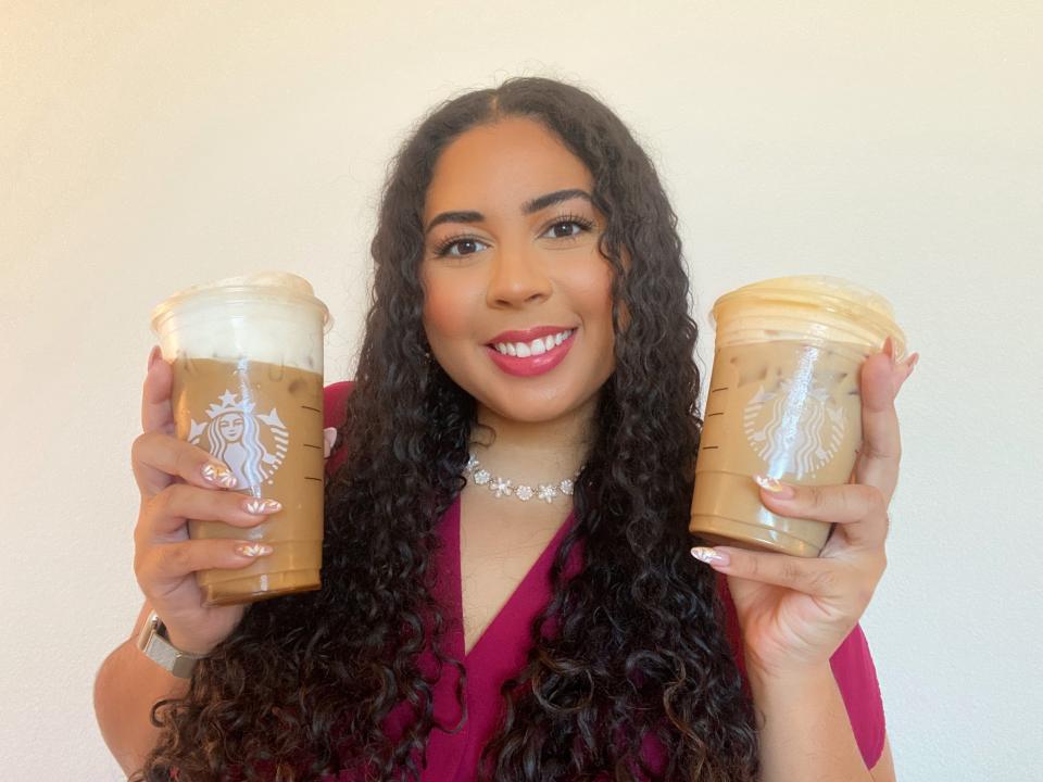 Melissa holding Starbucks drinks.