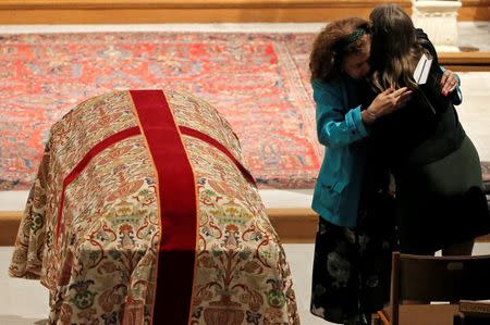 A mourner hugs Christine Leinonen (R), mother of Christopher Leinonen, who was killed at the Pulse gay nightclub, during a funeral service at Cathedral Church of St. Luke in Orlando, Florida, June 18, 2016. REUTERS/Jim Young