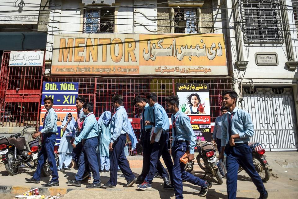 Students leave a school in Karachi, Pakistan, that was closed by the provincial government in late February.