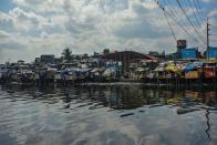 TOPSHOT - This photo taken on March 18, 2020 shows a general view of a slum area along the river in Manila. - Asian nations have imposed increasingly heavy measures to fight the outbreak of the COVID-19 coronavirus, the Philippines has ordered half its population of some 110 million to stay home. (Photo by Maria TAN / AFP) / TO GO WITH Health-virus-Philippines-poverty,FOCUS by Joshua Melvin and Ron Lopez (Photo by MARIA TAN/AFP via Getty Images)