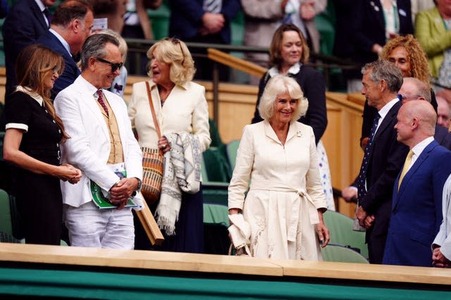 Queen Camilla walks to her seat in the Royal Box
