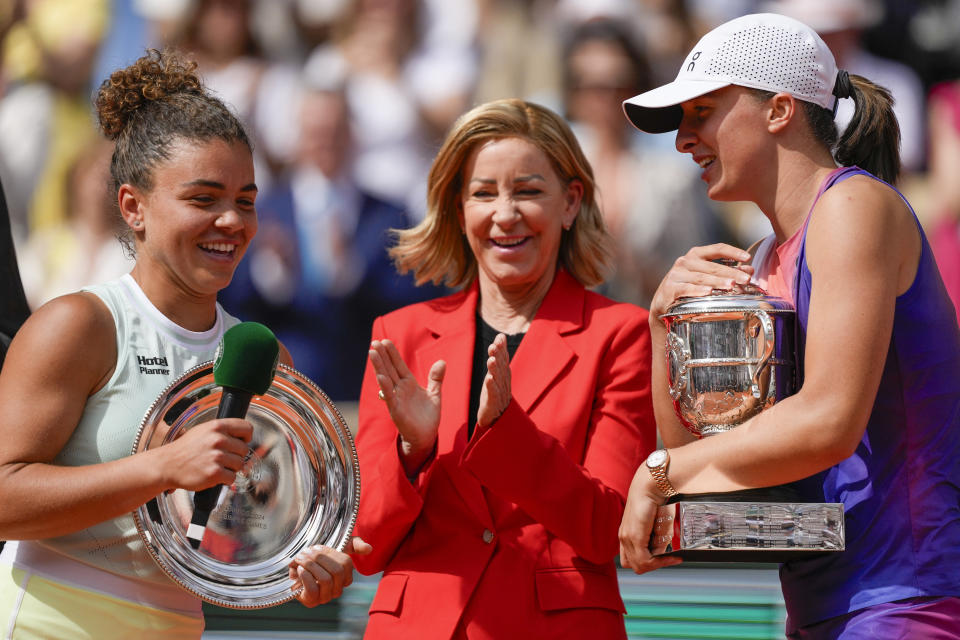 Poland's Iga Swiatek, right, holds the trophy after winning the women's final of the French Open tennis tournament against Italy's Jasmine Paolini, left, at the Roland Garros stadium in Paris, France, Saturday, June 8, 2024. (AP Photo/Thibault Camus)