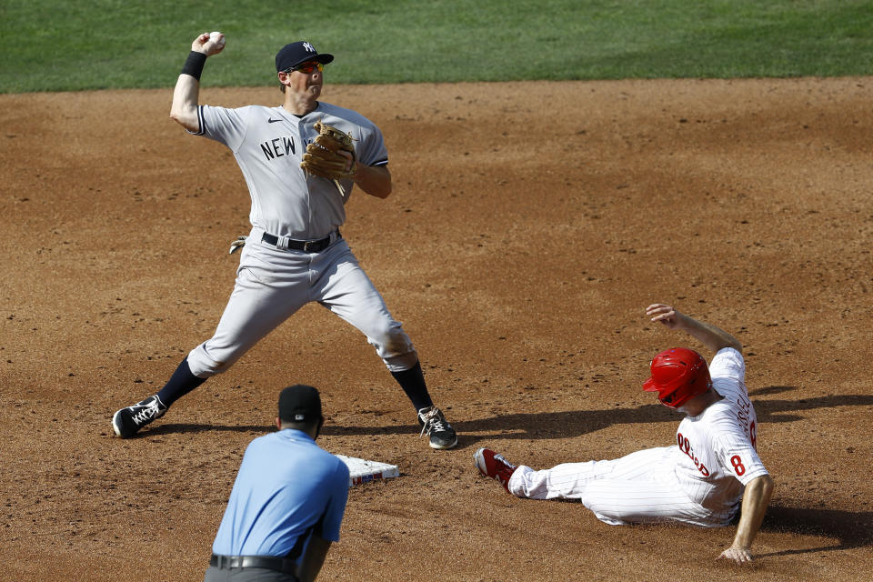 New York Yankees second baseman DJ LeMahieu, left, throws to first after forcing out Philadelphia Phillies' Phil Gosselin, right, at second on a run scoring fielder's choice hit by Roman Quinn during the third inning of the first baseball game in doubleheader, Wednesday, Aug. 5, 2020, in Philadelphia. (AP Photo/Matt Slocum)