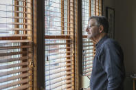 John Kriegshauser, nephew of Lt. John G. Kriegshauser, looks out the window of his home in Chicago on Feb. 14, 2019. He will be in Sheffield, England, to see the U.S. and Royal Air Force honor his uncle for deciding not to land his crippled plane on the grass at Sheffield's Endcliffe Park to avoid a group of children, choosing to crash and die rather than take the chance of hitting them. (AP Photo/Teresa Crawford)