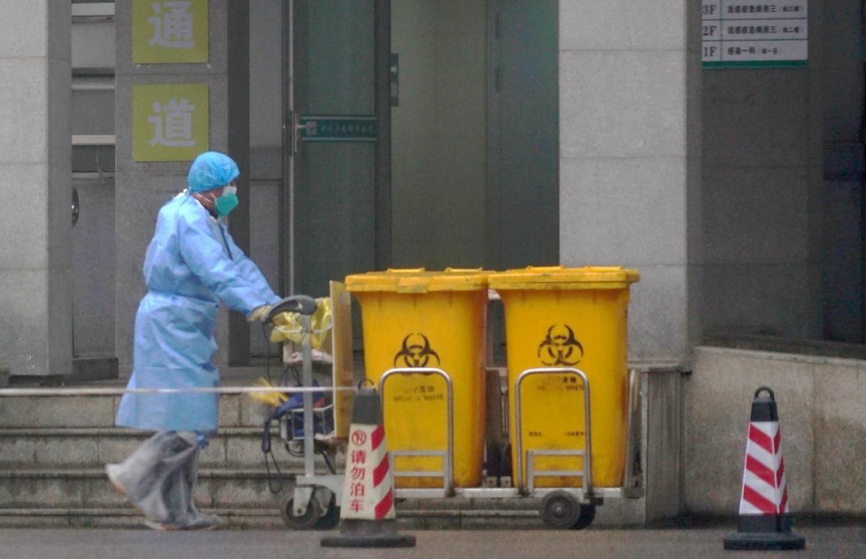 <span class="caption">A worker in Wuhan, China removes biomedical waste from the Wuhan Medical Treatment Center, where many patients of the coronavirus have been treated, on Jan. 22, 2020.</span> <span class="attribution"><a class="link " href="http://www.apimages.com/metadata/Index/APTOPIX-China-Outbreak/d80233b361984d84801b823d4c579aa2/10/0" rel="nofollow noopener" target="_blank" data-ylk="slk:Dake Kang/AP Photo;elm:context_link;itc:0;sec:content-canvas">Dake Kang/AP Photo</a></span>