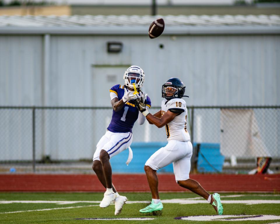 Westgate's Davian “Diamond” Jackson prepares to catch a ball over a Carencro football player during the Tigers scrimmage agaisnt the Bears at Tiger Stadium on Thursday, Aug. 22, 2024.