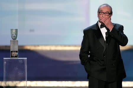 Actor James Garner covers his mouth at the 11th annual Screen Actors Guild awards at the Shrine Auditorium in Los Angeles in this February 5, 2005 file photo. REUTERS/Lucy Nicholson/Files