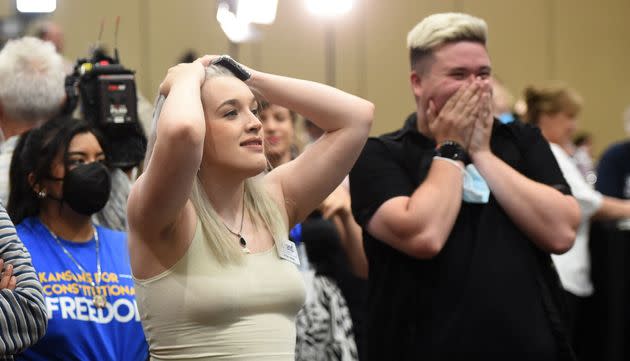 Pro-choice supporters Alie Utley and Joe Moyer (R) react to their county voting against the proposed constitutional amendment during the Kansas for Constitutional Freedom primary election watch party in Overland Park, Kansas, on Aug. 2. (Photo: DAVE KAUP via Getty Images)