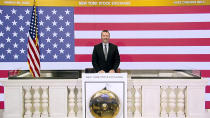 In this photo taken from video provided by the New York Stock Exchange, Director of Facilities & Building Operations James Katsarelis rings the opening bell at the NYSE, on Wednesday, March 25, 2020. Stocks are wobbling in tentative trading Wednesday as a historic, worldwide rally downshifts dramatically after just a day. (New York Stock Exchange via AP)