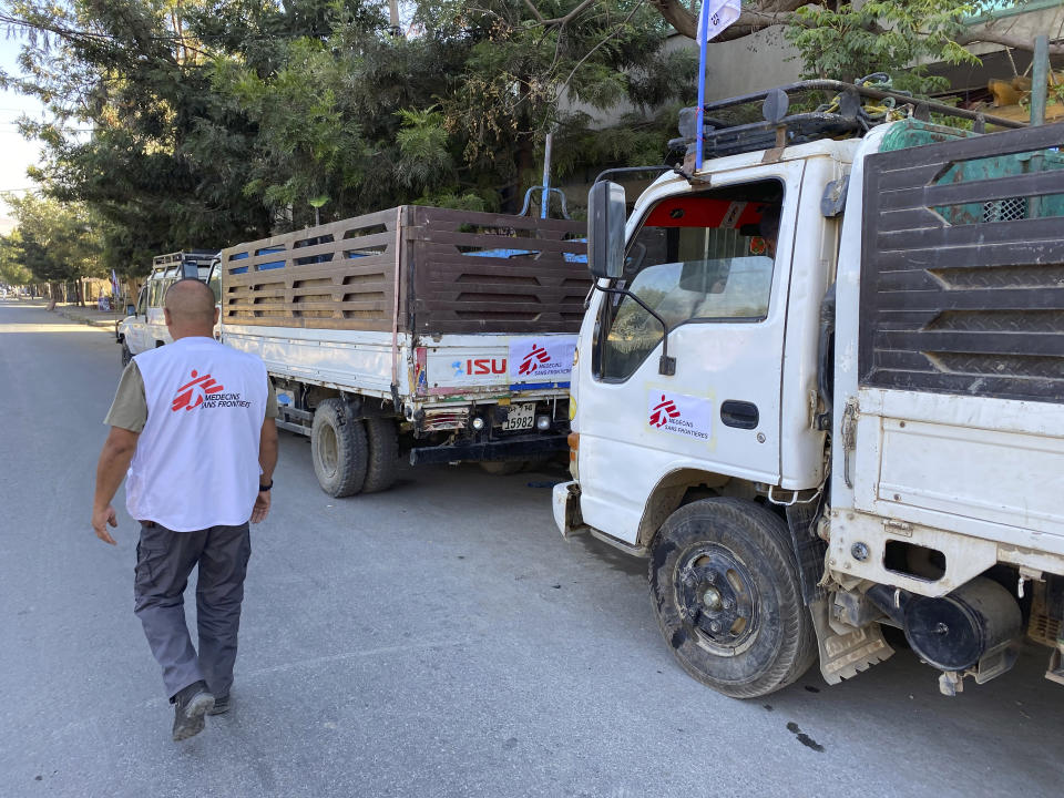 In this Sunday, Jan. 3, 2021 photo provided by Medecins Sans Frontieres, a Medecins Sans Frontieres, worker supervises trucks being loaded with supplies in Mekele to be sent to other parts of the Tigray region in northern Ethiopia. From “emaciated” refugees to crops burned on the brink of harvest, starvation threatens the survivors of more than two months of fighting in Ethiopia’s Tigray region. Authorities say more than 4.5 million people, or nearly the entire population, need emergency food. The first humanitarian workers to arrive after weeks of pleading with Ethiopia for access describe weakened children dying from diarrhea after drinking from rivers, and shops that were looted or depleted weeks ago. (Medecins Sans Frontieres via AP)