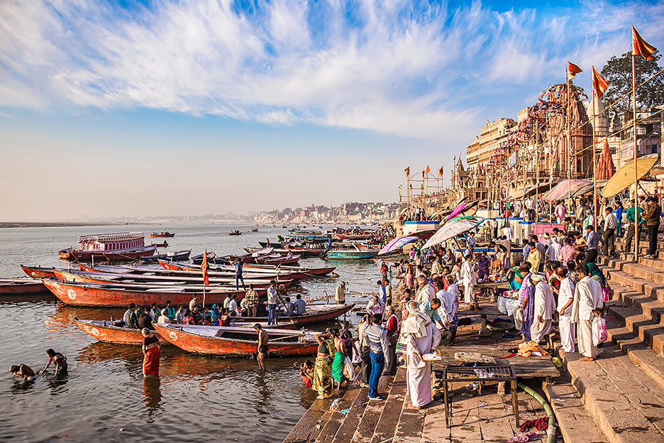 In the holy city of Varanasi, people pray and bathe in the Ganges River. 