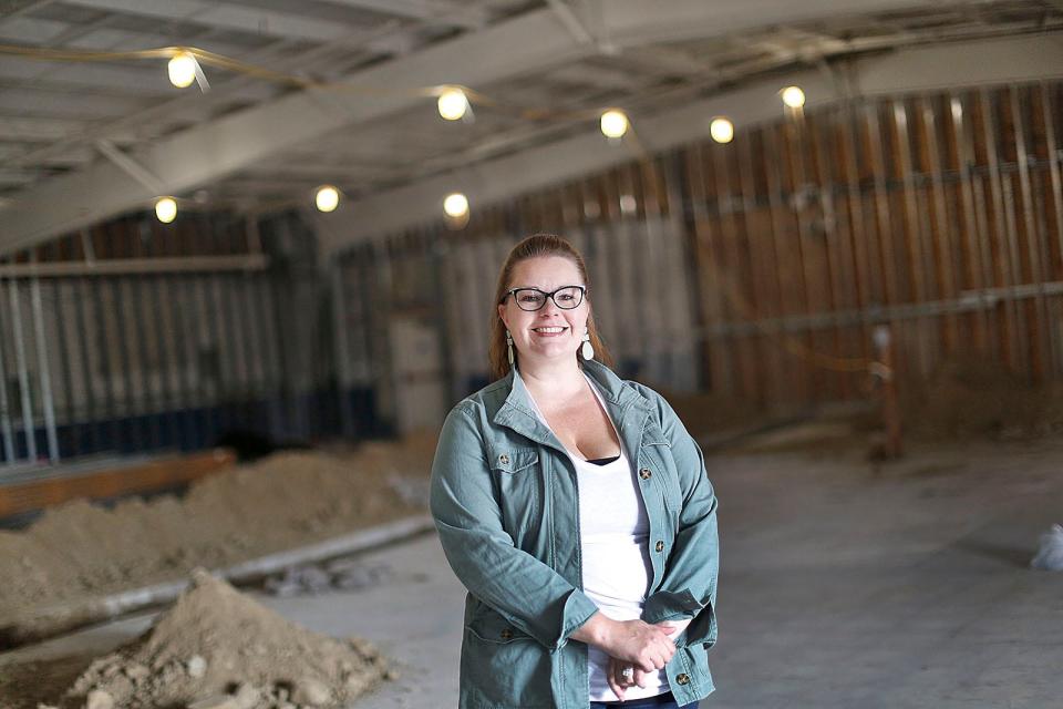 Caitlyn Woodward- Samson, vice president of retail for Native Sun cannabis company, is pictured Aug. 10 inside a closed Pier One Imports store in Braintree, Mass. which will be converted to a medical marijuana dispensary.