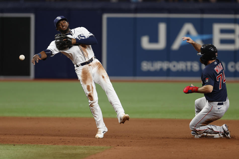 Tampa Bay Rays second baseman Vidal Brujan, left, attempts a double play after forcing out Boston Red Sox's Connor Wong, right, at second during the ninth inning of a baseball game Monday, Sept. 5, 2022, in St. Petersburg, Fla. Red Sox's Alex Verdugo advanced to second on a wild throw. (AP Photo/Scott Audette)