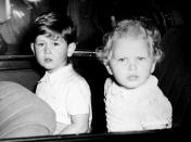 <p>A super sweet Princess Anne, 2, goes for a drive with her big bro Prince Charles back in 1952. [Photo: PA Images] </p>