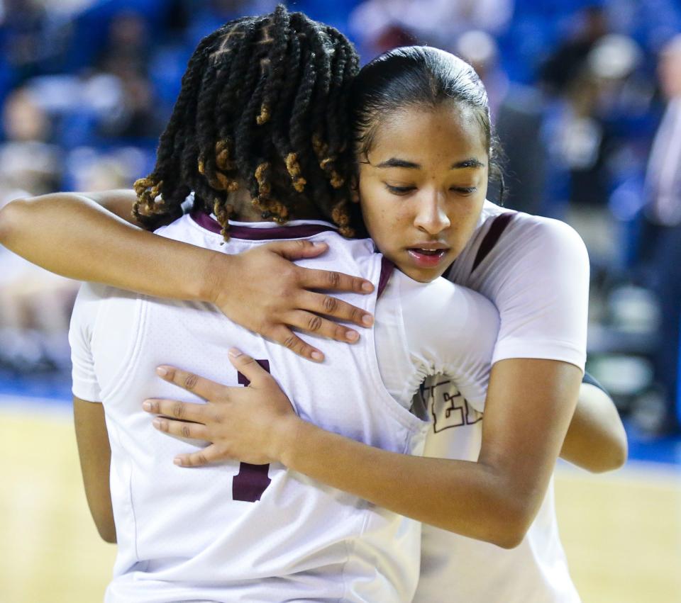 Caravel's Anaya Price (facing camera) and Chasity Wilson share a consoling hug after Ursuline's 49-48 win in the DIAA championship at the Bob Carpenter Center, Saturday, March 9, 2024.