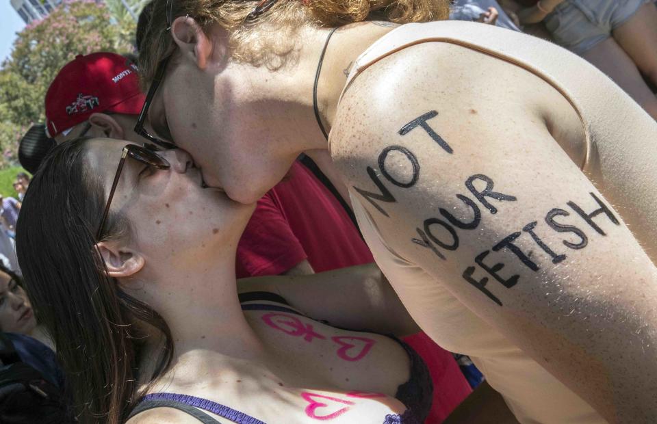 Participants kiss during the annual 'SlutWalk' in Tel Aviv on July 08, 2016 to protest against rape culture, including sexual assault and harassment directed at women.