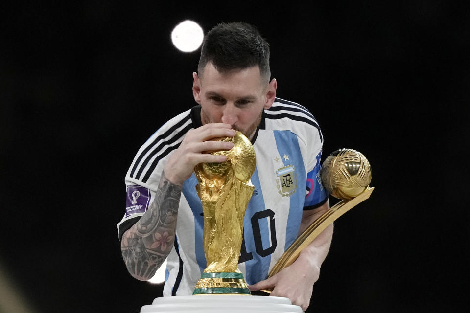 CORRECTS SPELLING Argentina's Lionel Messi kisses the trophy after winning the World Cup final soccer match between Argentina and France at the Lusail Stadium in Lusail, Qatar, Sunday, Dec. 18, 2022. Argentina won 4-2 in a penalty shootout after the match ended tied 3-3. (AP Photo/Martin Meissner)