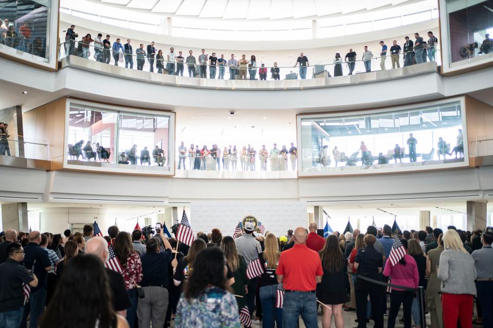 A crowd gathers at the headquarters of American Airlines before the honor flight.