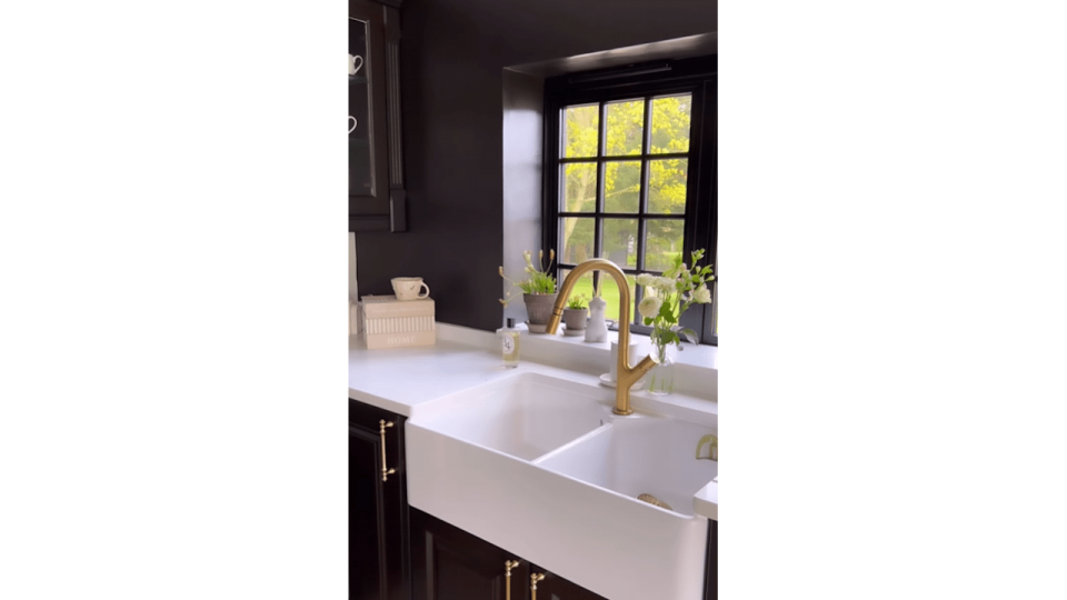 black kitchen featuring a farmhouse sink