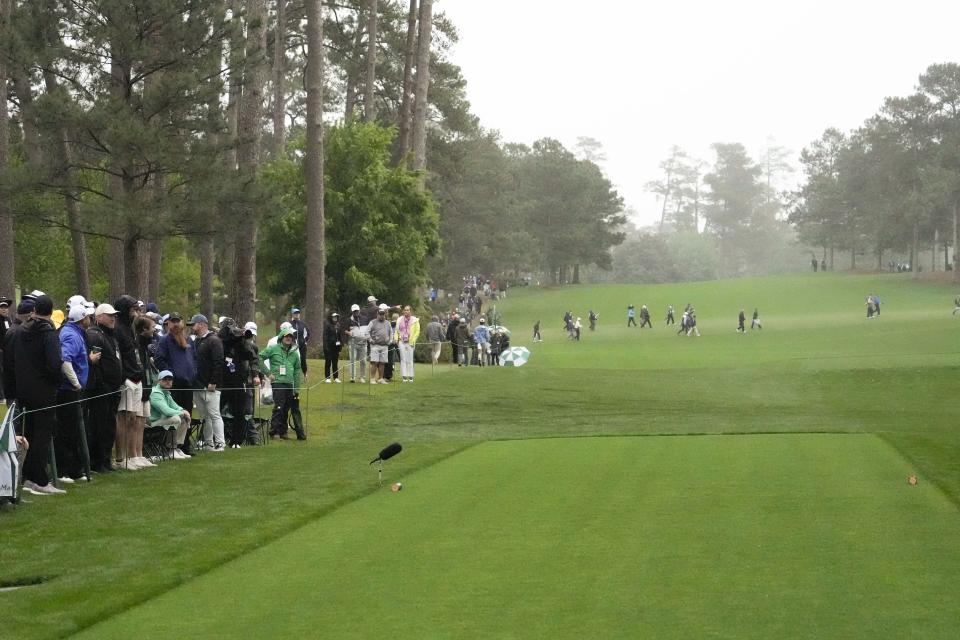 Patrons stand near the 17th hole during the second round of the Masters golf tournament at Augusta National Golf Club on Saturday, April 8, 2023, in Augusta, Ga. Three towering pine trees fell near patrons as storms rolled through Augusta National on Friday with no evidence of the aftermath that can be seen less than 24 hours later. (AP Photo/Mark Baker)