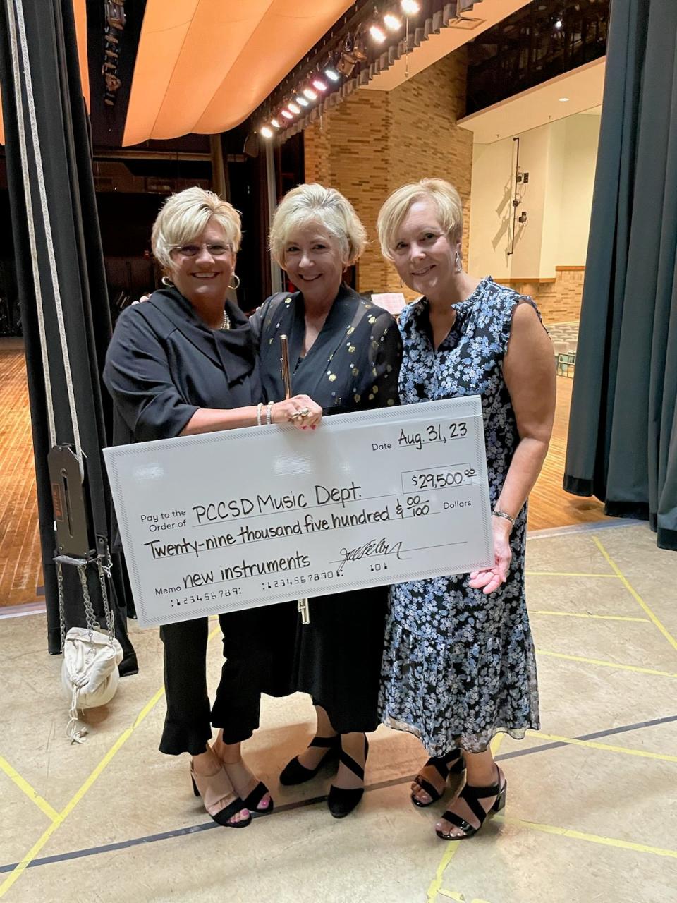 Concert organizer Diane Warnke Hawk with internationally acclaimed flutist Jill Felber and Jan Gluth, Director of Student, Staff and Community Development for Port Clinton City Schools, prepare for the check presentation to the Port Clinton Schools Music Department.