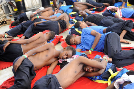 Migrants are seen resting on board the MV Aquarius rescue ship run by SOS Mediterranee organisation and Doctors Without Borders during a search and rescue (SAR) operation in the Mediterranean Sea, off the Libyan Coast, August 12, 2018. Picture taken August 12, 2018. REUTERS/Guglielmo Mangiapane