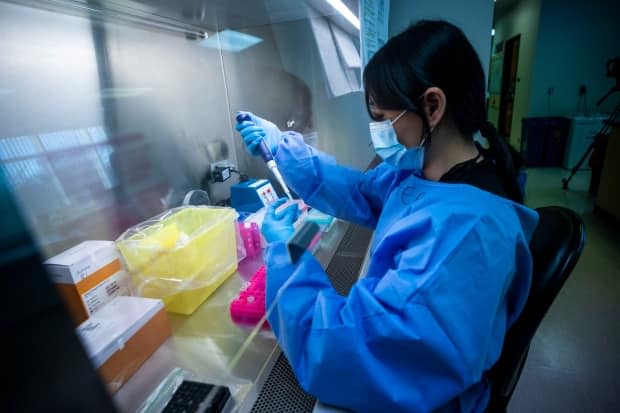 Laboratory technologists work to sequence the genome of the SARS-CoV-2 virus on Tuesday, January 19, 2021, at the BCCDC in Vancouver, British Columbia.  (Ben Nelms/CBC – photo credit)