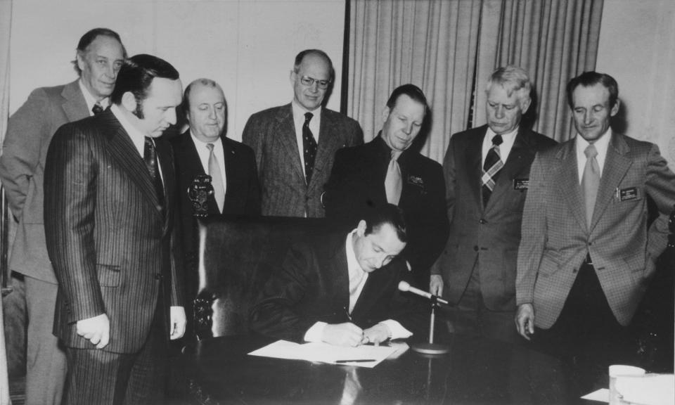 Former South Dakota Governor Richard Kneip signs Senate Bill 30 into law in 1974.