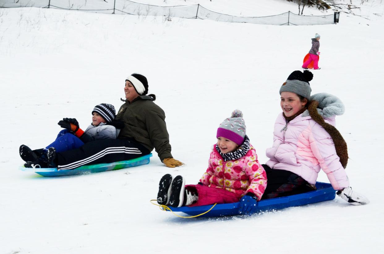 Abigail and Jackson Westphal (back) sled together with Emilia Westphal and Olivia Kunz (front) on Wednesday, Dec. 28, 2022 at the Winter Sports Park in Petoskey.