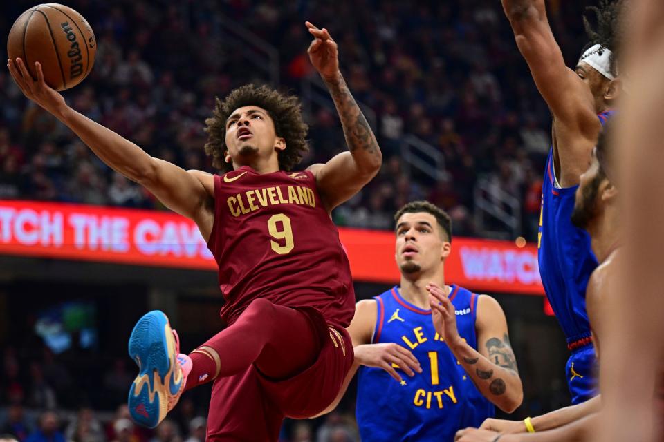 Cavaliers guard Craig Porter goes to the basket against Denver Nuggets forward Michael Porter Jr. on Nov. 19, 2023, in Cleveland