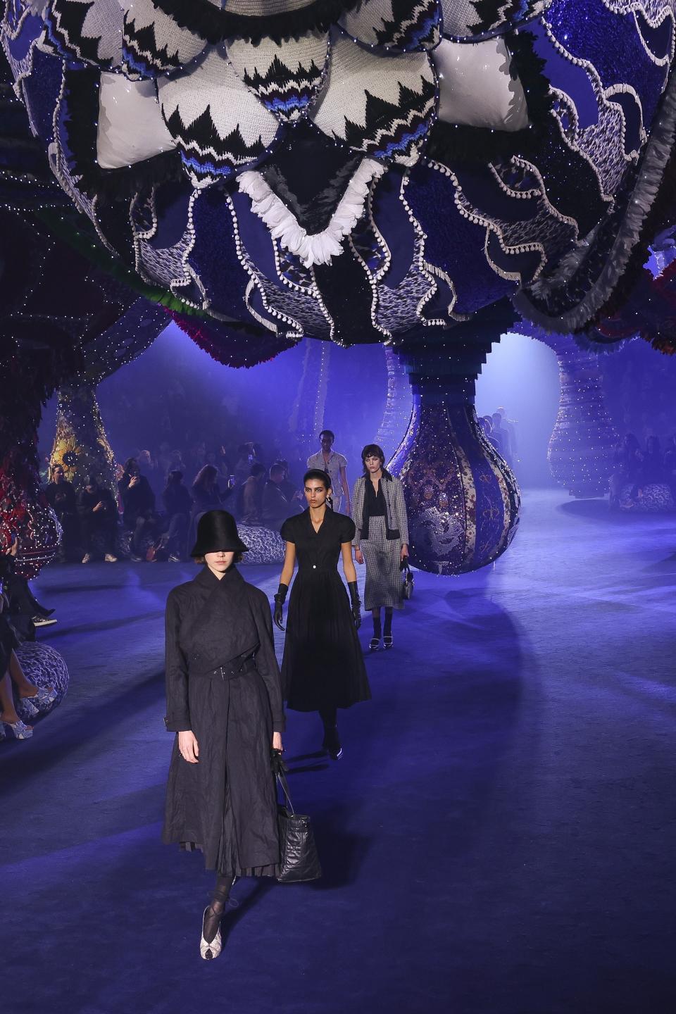 Models wear creations as part of the Christian Dior Fall/Winter 2023-2024 ready-to-wear collection presented Tuesday, Feb. 28, 2023 in Paris. (Vianney Le Caer/Invision/AP)