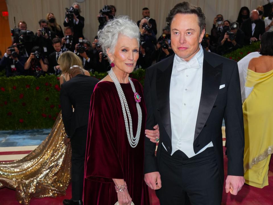 Maye Musk and Elon Musk posing for photographers on the red carpet of the Met Gala.