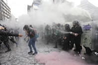 Demonstrators clash with riot police during a march supporting abortion rights in Mexico City, Monday, Sept. 28, 2020. (AP Photo/Marco Ugarte)