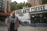 Chris Vigilante poses in front of one of his coffee shops, Wednesday, Sept. 1, 2021, in College Park, Md. A confluence of supply chain problems, drought, frost and inflation all point to the price of your cup of morning coffee going up. The tricky part is trying to figure when — and how much. (AP Photo/Julio Cortez)