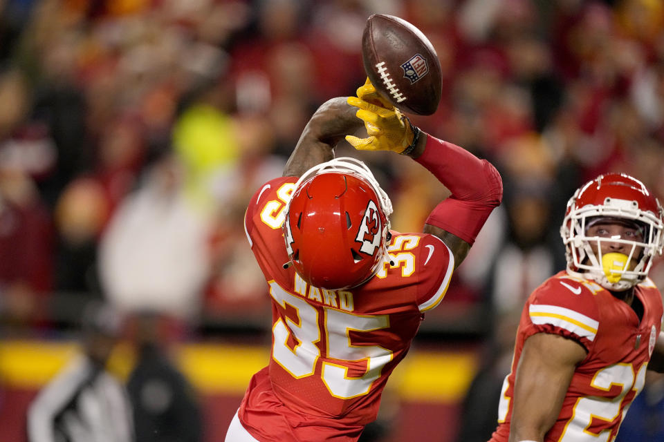 Kansas City Chiefs cornerback Charvarius Ward (35) is unable to intercept a pass as teammate Mike Hughes (21) watches during the first half of an NFL football game against the Denver Broncos Sunday, Dec. 5, 2021, in Kansas City, Mo. (AP Photo/Charlie Riedel)