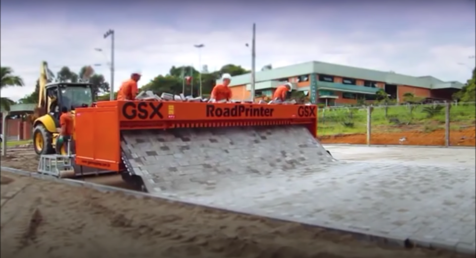 These brick-laying machines semi-automatically roll out roads in a deeply satisfying way.