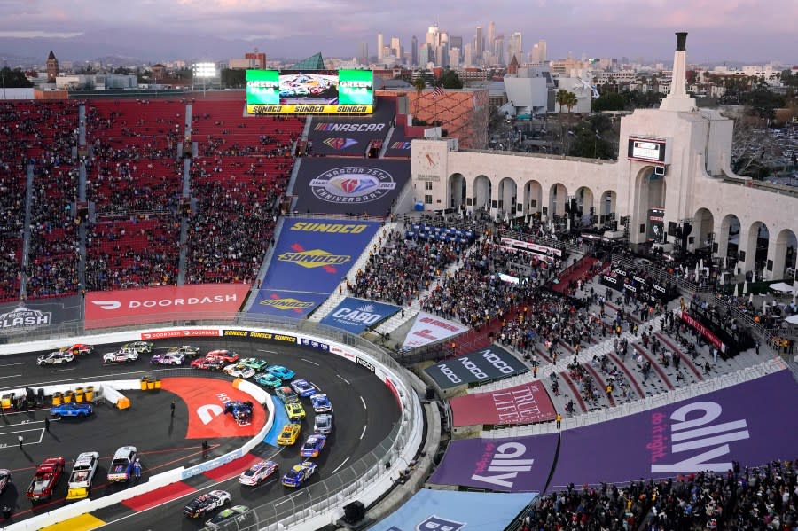 FILE - Cars race around the track as downtown Los Angeles is seen in the background during the Busch Light Clash NASCAR exhibition auto race at Los Angeles Memorial Coliseum Sunday, Feb. 5, 2023, in Los Angeles. NASCAR returns to Los Angeles Memorial Coliseum for a third consecutive year for the exhibition Clash and the immediate future of racing in Southern California is at stake. (AP Photo/Mark J. Terrill, File)