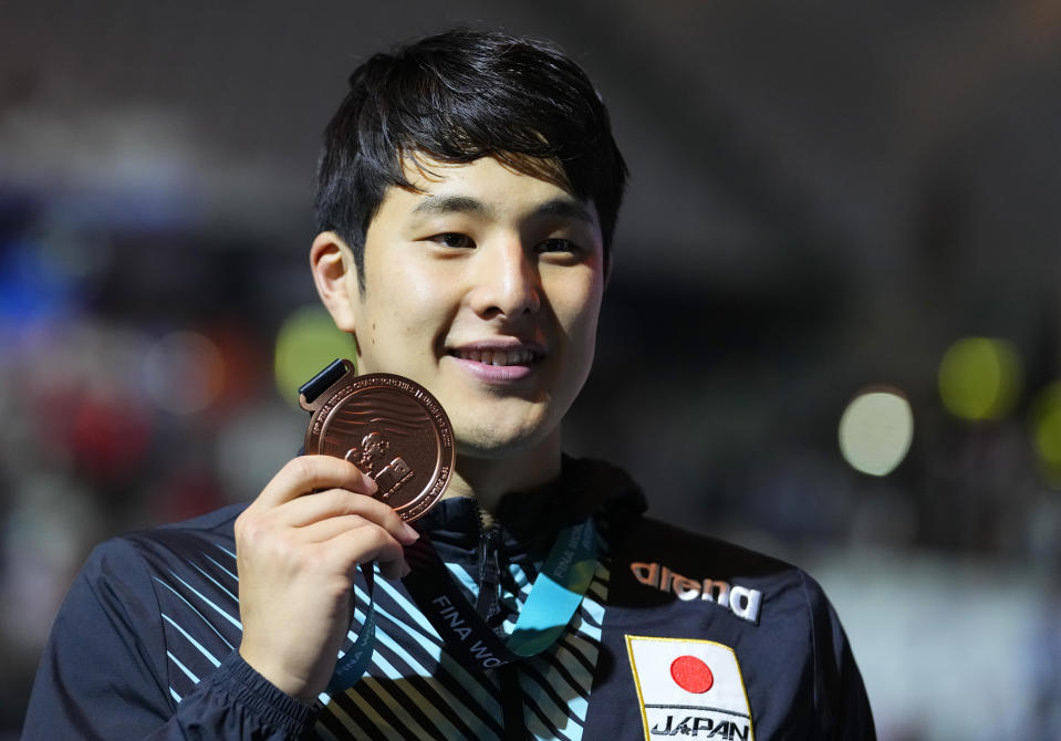 Bronze medalist Daiya Seto of Japan poses with his medal after the Men 200m Medley final at the 19th FINA World Championships in Budapest, Hungary, Wednesday, June 22, 2022. (AP Photo/Petr David Josek)