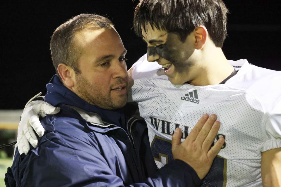 Archbishop Williams coach Matt Reggianini hugs Marcus Thurston during a game on Wednesday, Nov. 24, 2021.