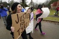 A group of demonstrators protest outside a police precinct in response to the death of Tyre Nichols, who died after being beaten by Memphis police officers, in Memphis, Tenn., Sunday, Jan. 29, 2023. (AP Photo/Gerald Herbert)